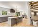 Modern kitchen with gray cabinets, a waterfall island, stainless steel appliances, and hardwood floors at 1327 Harvard Ne Rd, Atlanta, GA 30306