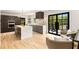 Modern kitchen with island, stainless appliances, wood floors, and sliding glass doors to the outdoor patio at 1327 Harvard Ne Rd, Atlanta, GA 30306