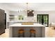 Open concept kitchen with a large island, modern lighting, stainless steel appliances, and an exterior door at 1327 Harvard Ne Rd, Atlanta, GA 30306