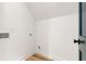 A minimalist laundry room with hookups, white walls, and wood-look flooring at 1327 Harvard Ne Rd, Atlanta, GA 30306