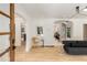 Open-concept living room with hardwood floors, arched doorways, and modern lighting fixtures at 1327 Harvard Ne Rd, Atlanta, GA 30306