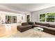 Inviting living room with hardwood floors, abundant natural light, and stylish sectional sofa and decor at 1327 Harvard Ne Rd, Atlanta, GA 30306