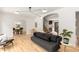 Bright living room featuring hardwood floors, an arched doorway, and a stylish modern sofa at 1327 Harvard Ne Rd, Atlanta, GA 30306