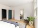 Bright main bedroom featuring light hardwood floors, modern doorways, and a view of the ensuite bathroom at 1327 Harvard Ne Rd, Atlanta, GA 30306