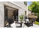 Private outdoor patio with black chairs, a palm plant, and access to the interior via french doors at 1327 Harvard Ne Rd, Atlanta, GA 30306