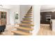 Modern, light-filled home featuring natural wood floating staircase and sight-lines into the kitchen at 1327 Harvard Ne Rd, Atlanta, GA 30306