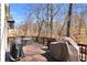 Expansive wooden back deck with outdoor dining area and grill overlooking a private wooded backyard at 1604 Summersweet Ln, Dacula, GA 30019