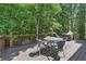 Comfortable back deck features outdoor seating and overlooks a peaceful wooded backyard setting at 1604 Summersweet Ln, Dacula, GA 30019