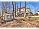 Relaxing backyard featuring a deck with stairs, a shed, and a fire pit, perfect for outdoor entertaining at 1604 Summersweet Ln, Dacula, GA 30019