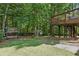 Large backyard featuring a playhouse and mature trees, offering a private outdoor space at 1604 Summersweet Ln, Dacula, GA 30019