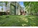 Beautiful backyard with a wooden deck and access to a playhouse in a serene wooded setting at 1604 Summersweet Ln, Dacula, GA 30019