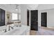 Bright bathroom featuring a soaking tub, glass shower, and a modern vanity at 1604 Summersweet Ln, Dacula, GA 30019