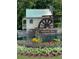 Iconic landmark in the Hamilton Mill community: a charming watermill with lush floral landscaping at 1604 Summersweet Ln, Dacula, GA 30019