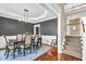 Dining room with hardwood floors and wainscoting near the staircase and foyer at 1604 Summersweet Ln, Dacula, GA 30019