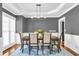 Formal dining room with hardwood floors, decorative chandelier, and wainscoting at 1604 Summersweet Ln, Dacula, GA 30019