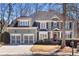 Charming two-story home with a manicured lawn, two-car garage and an American flag at 1604 Summersweet Ln, Dacula, GA 30019