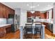 Modern kitchen featuring a center island, stainless steel appliances, and hardwood floors at 1604 Summersweet Ln, Dacula, GA 30019