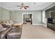 Comfortable living room with ceiling fan and open access to the breakfast bar at 1604 Summersweet Ln, Dacula, GA 30019
