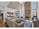 Open-concept living room with stone fireplace and view to kitchen and high ceilings at 1604 Summersweet Ln, Dacula, GA 30019