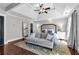 Primary suite featuring hardwood floors, tray ceiling, sofa, and large windows at 1604 Summersweet Ln, Dacula, GA 30019
