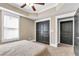 Main bedroom with tray ceiling, carpet flooring, closet, and natural light streaming in from the window at 1604 Summersweet Ln, Dacula, GA 30019