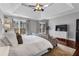 Large primary suite featuring hardwood floors, tray ceiling, sofa, and large windows at 1604 Summersweet Ln, Dacula, GA 30019