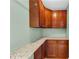 Well-organized pantry with beautiful granite countertops and dark brown cabinets at 1604 Summersweet Ln, Dacula, GA 30019