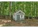 Charming playhouse in a wooded backyard setting, perfect for outdoor adventures at 1604 Summersweet Ln, Dacula, GA 30019