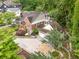 Aerial view showcasing a brick home with a two-car garage and lush landscaping at 228 Clarion Ave, Decatur, GA 30030