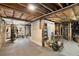 Unfinished basement with exposed wooden ceiling beams and exercise equipment at 228 Clarion Ave, Decatur, GA 30030