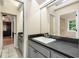 Bathroom vanity with granite countertop and a view into the bedroom at 228 Clarion Ave, Decatur, GA 30030