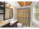 Well-lit bathroom with vanity, mirror, and decorative shower curtain at 228 Clarion Ave, Decatur, GA 30030