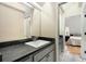 Modern bathroom vanity with granite counters, mirror, and contemporary fixtures at 228 Clarion Ave, Decatur, GA 30030