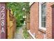 Charming brick home featuring a walkway and lush landscaping at 228 Clarion Ave, Decatur, GA 30030