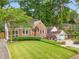Charming brick home with a well-maintained front yard and mature trees at 228 Clarion Ave, Decatur, GA 30030