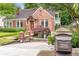 Charming brick home featuring a well-manicured lawn and a brick walkway leading to the front door at 228 Clarion Ave, Decatur, GA 30030