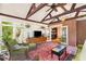 Bright sunroom with brick floors, vaulted ceilings, and lots of windows for natural light and hanging plants at 228 Clarion Ave, Decatur, GA 30030