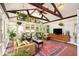 Bright sunroom with brick floors, vaulted ceilings, and lots of windows for natural light and hanging plants at 228 Clarion Ave, Decatur, GA 30030