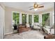 Cozy sunroom with tile floor, natural light, and comfortable seating at 228 Clarion Ave, Decatur, GA 30030