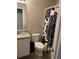 Compact bathroom with a sink, toilet, granite countertops and a stylish shower curtain at 30 Sloane Ct, Covington, GA 30016