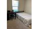 Bright bedroom with a desk, single bed and neutral carpeting, offering comfort and functionality at 30 Sloane Ct, Covington, GA 30016
