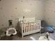 A modern Bedroom featuring a crib, baby swing, rocking chair and neutral color palette at 30 Sloane Ct, Covington, GA 30016