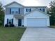 Charming two-story home with a large two car garage and a well maintained lawn at 30 Sloane Ct, Covington, GA 30016