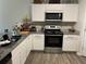 Well-lit kitchen features stainless appliances, granite countertops, and ample cabinet space at 30 Sloane Ct, Covington, GA 30016