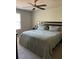 A well lit main bedroom with a ceiling fan and a comfortable looking queen sized bed at 30 Sloane Ct, Covington, GA 30016
