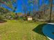 Green backyard with a storage shed, mature trees, and ample lawn space at 3082 Dove Way, Decatur, GA 30033