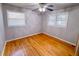 Cozy bedroom featuring hardwood floors, a ceiling fan, and two windows with blinds at 3082 Dove Way, Decatur, GA 30033