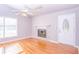 Bright living room with hardwood floors, fireplace, and a ceiling fan at 3082 Dove Way, Decatur, GA 30033