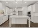Modern kitchen featuring white cabinets, quartz countertops, a large island, and stainless steel appliances at 3910 Near Star Ln, Cumming, GA 30028