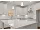 Bright, modern kitchen with quartz countertops, white cabinets, stainless steel appliances, and a stylish backsplash at 3910 Near Star Ln, Cumming, GA 30028